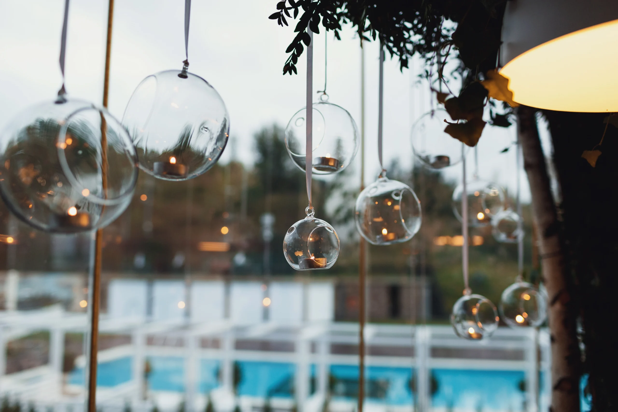glass-balls-with-candles-hang-before-window
